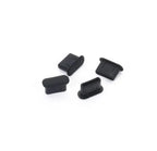 Four black silicone plugs on a white background