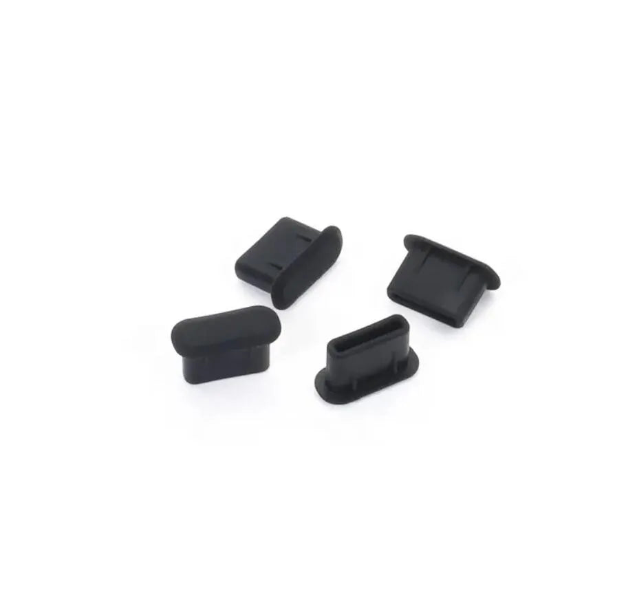Four black silicone plugs on a white background